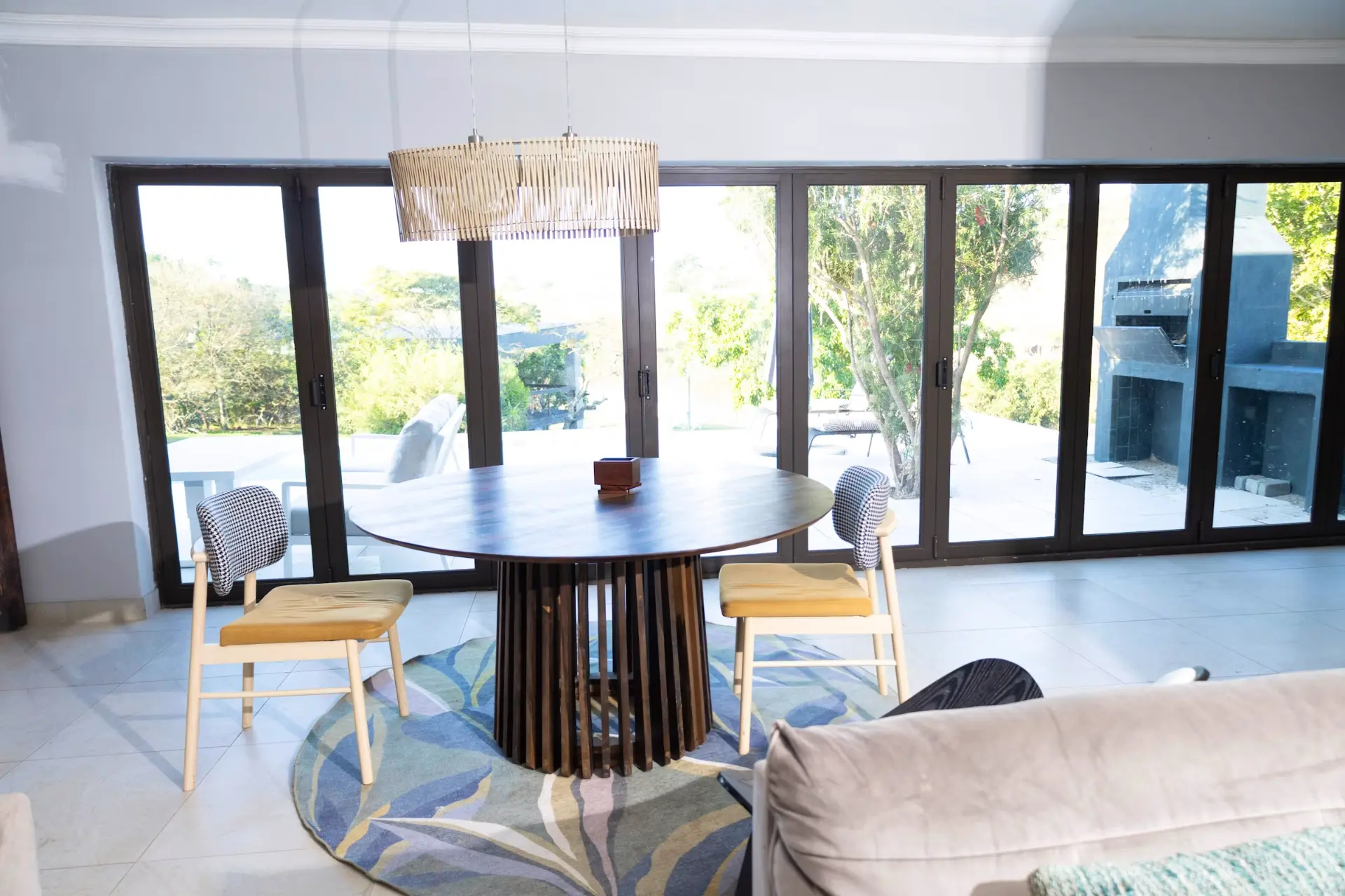 Round dining table with stacking doors opening onto the garden
