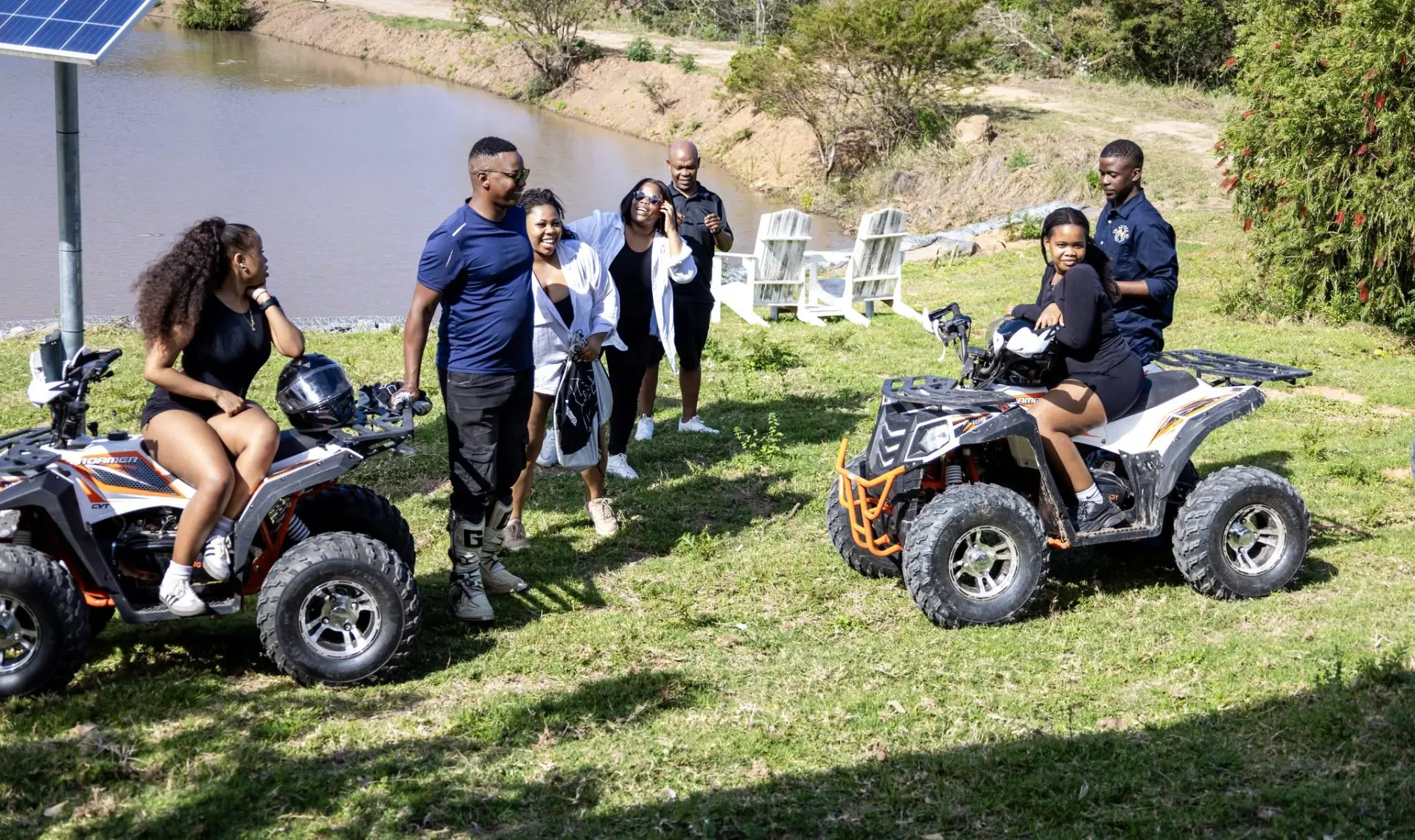 Guests enjoying quad bikes on the lawn beside the farm dam